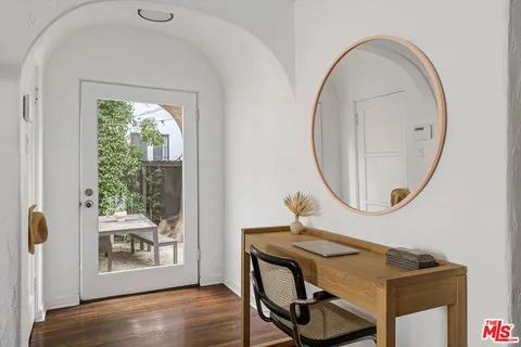 a view of a livingroom with furniture wooden floor and a window