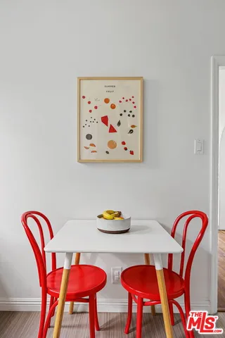 a dining room with furniture and wooden floor