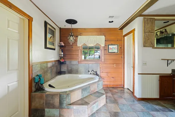 a bathroom with a tub and a shower