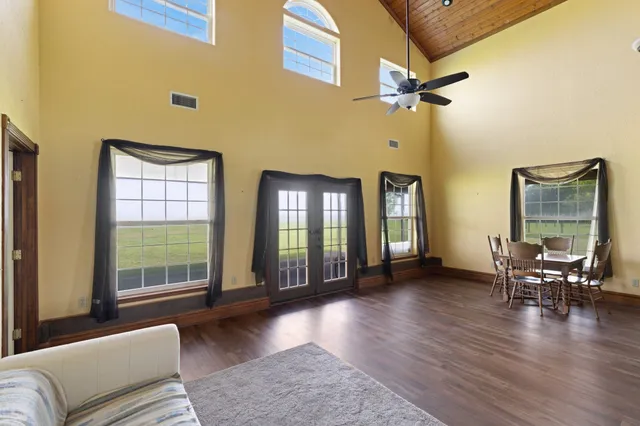 a living room with furniture and wooden floor