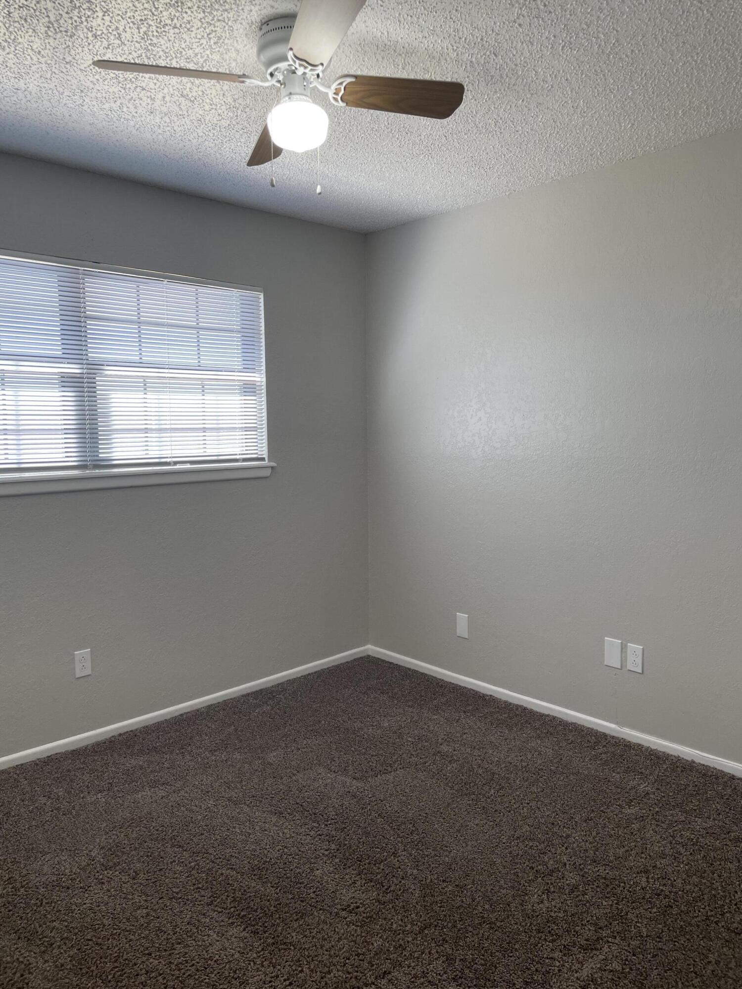6917 Fremont Avenue Lubbock, TX 79413 - Photo 7 of 9 an empty room with a window