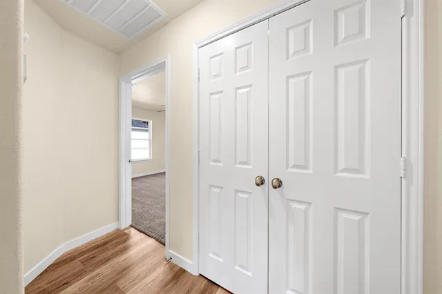 an empty room with wooden floor