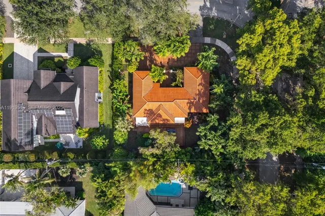 an aerial view of a house with a yard