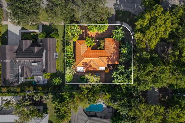an aerial view of a house with a yard and garden