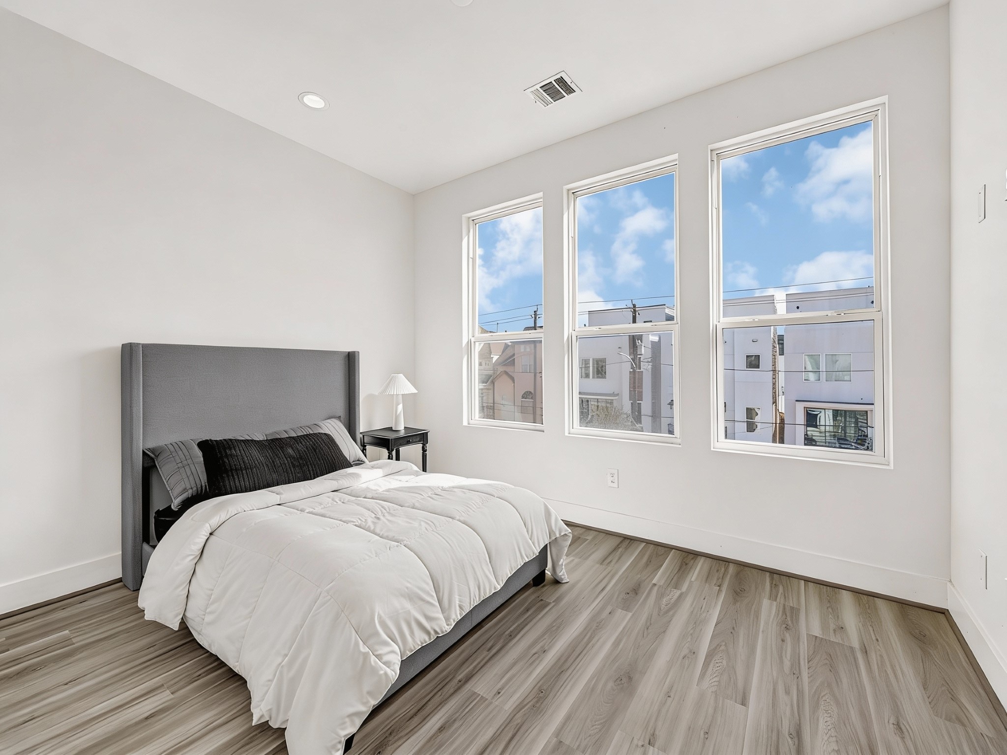 3313 Baer Street Houston, TX 77020 - Photo 18 of 35 a bedroom with a large bed and a large window