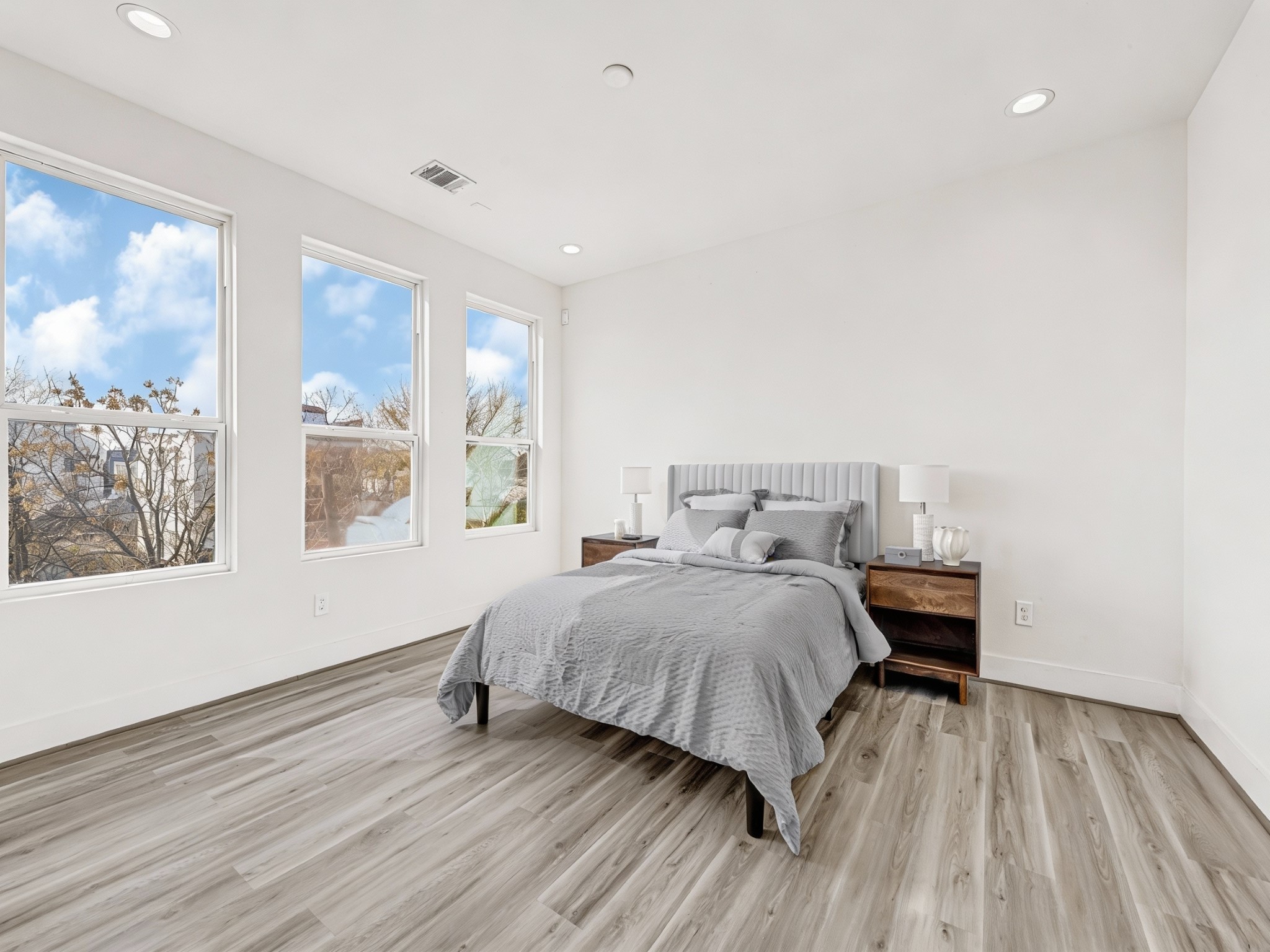 3313 Baer Street Houston, TX 77020 - Photo 21 of 35 a spacious bedroom with a bed and wooden floor