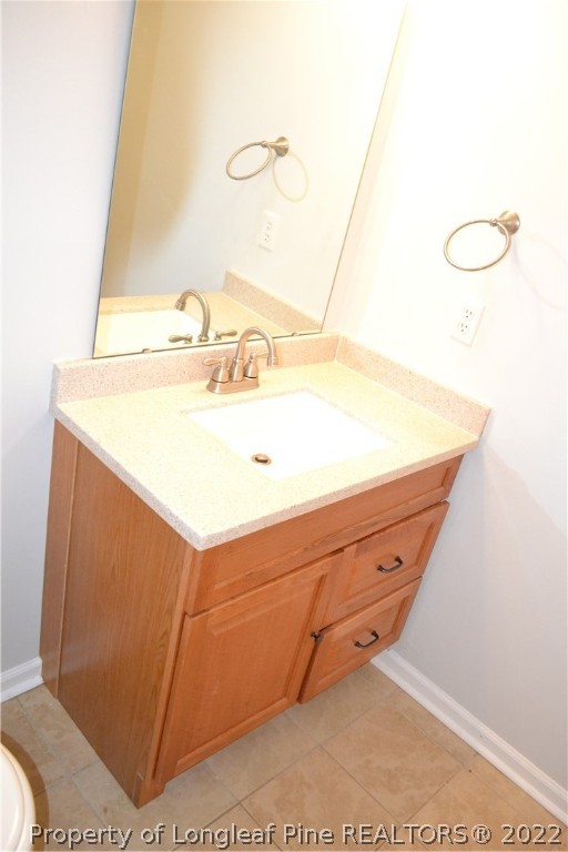 982 Rim Road Fayetteville, NC 28314 - Photo 18 of 20 a bathroom with a sink and a mirror