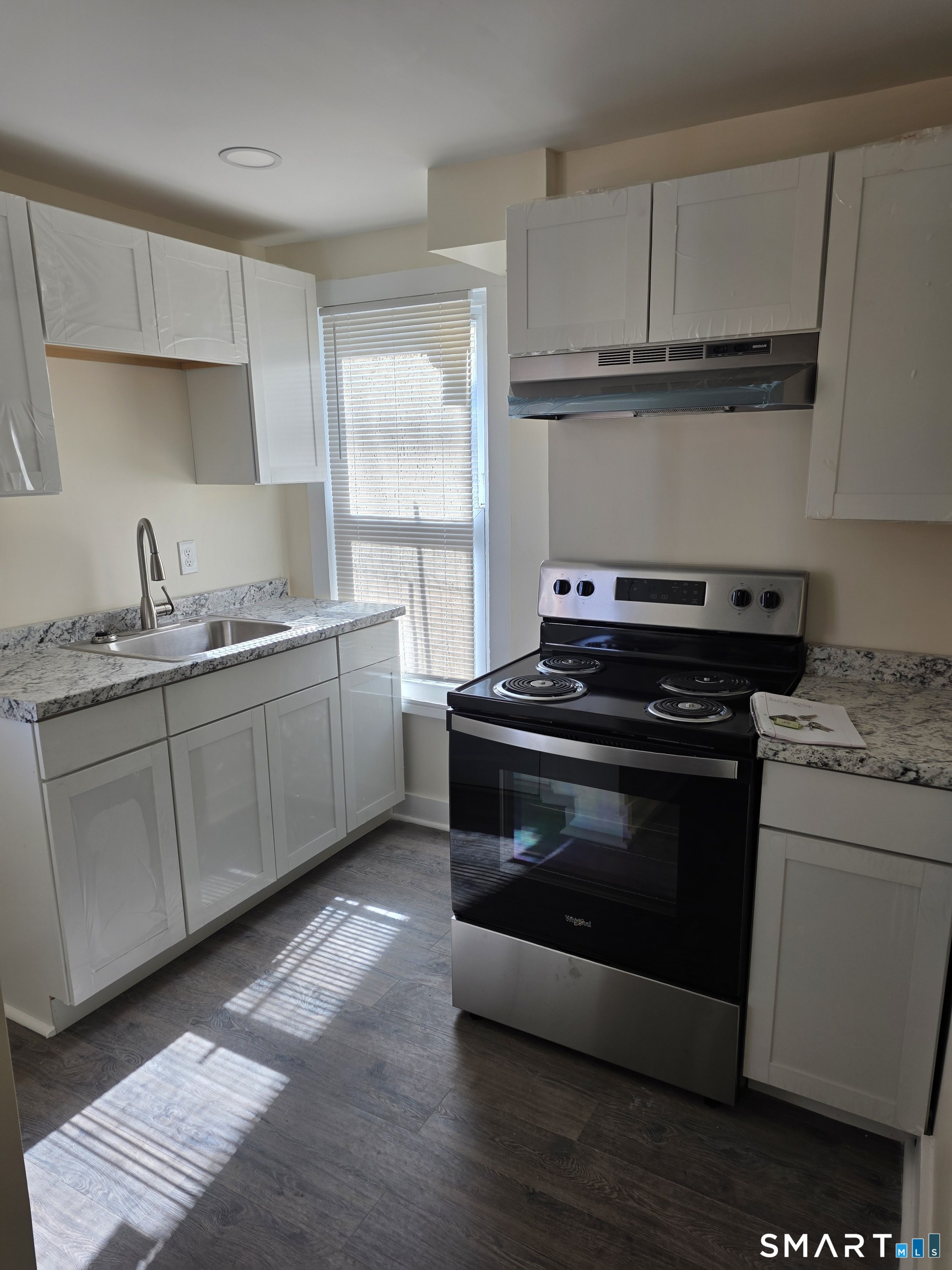 36 Reynolds Street Norwich, CT 06360 - Photo 3 of 17 a kitchen with a stove and a sink