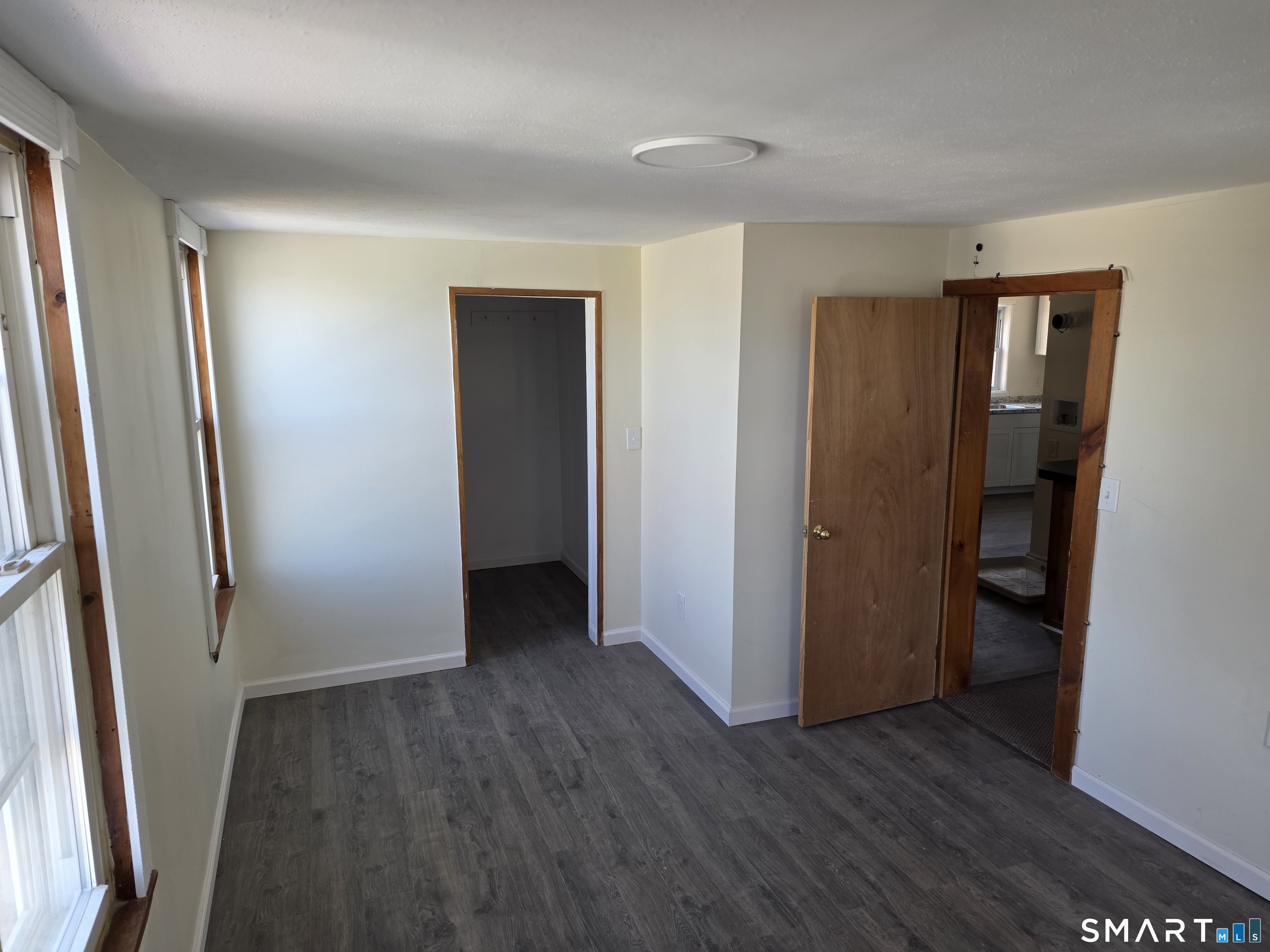 36 Reynolds Street Norwich, CT 06360 - Photo 7 of 17 an empty room with wooden floor and entrance