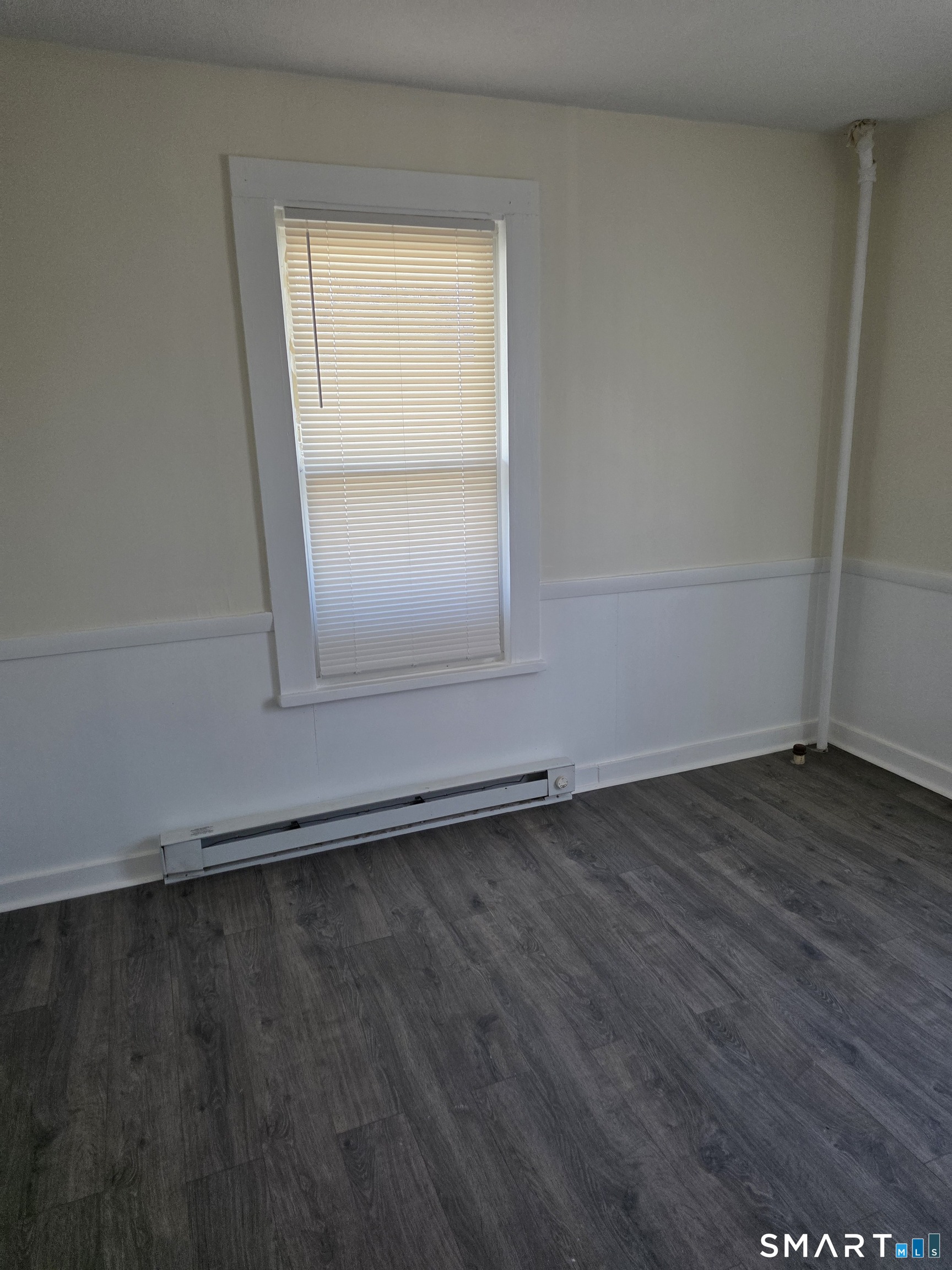 36 Reynolds Street Norwich, CT 06360 - Photo 9 of 17 an empty room with wooden floor and windows