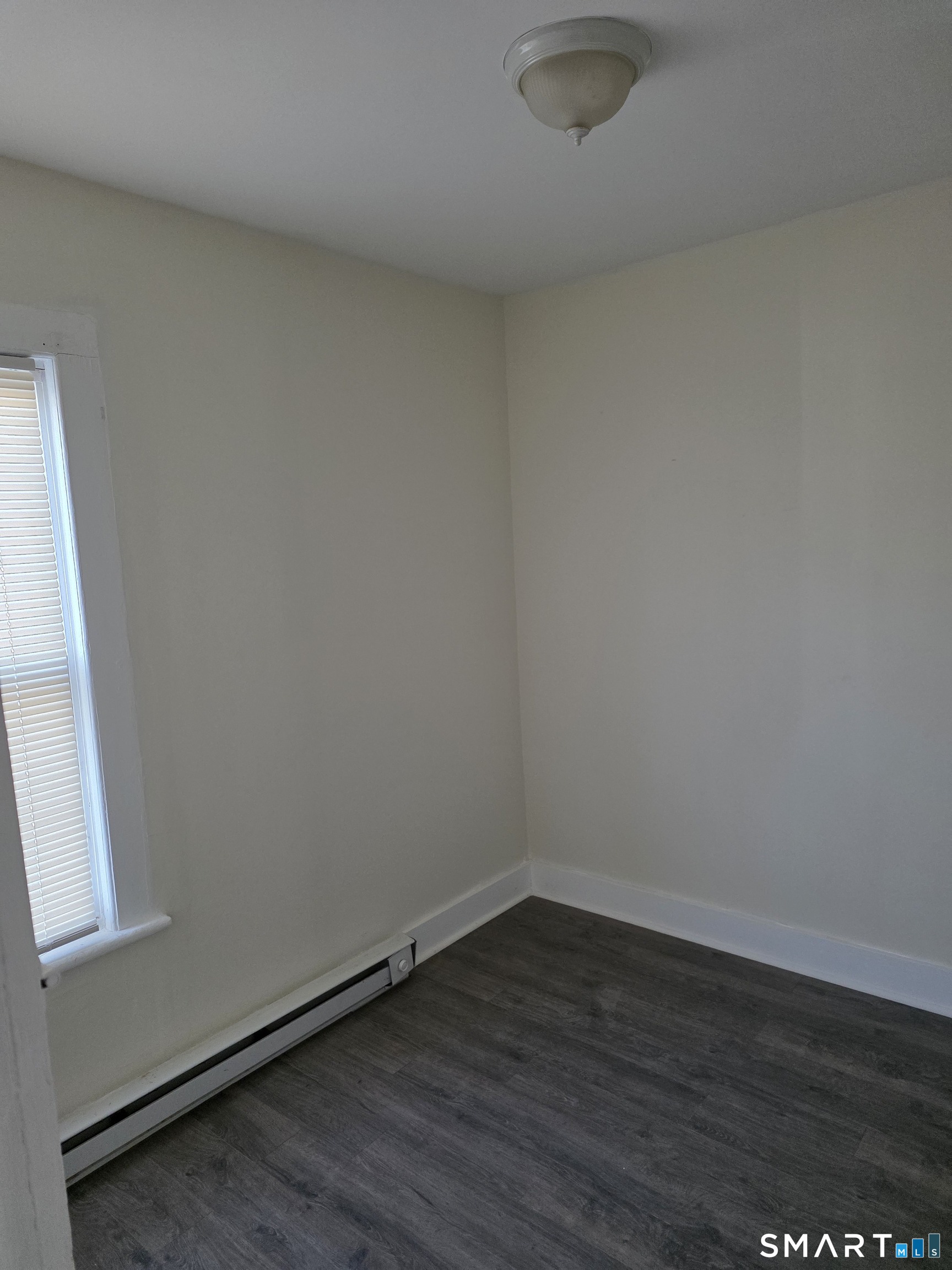36 Reynolds Street Norwich, CT 06360 - Photo 10 of 17 a view of a small space with wooden floor and a window