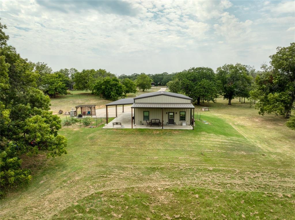 210 Spring Branch Trail North Springtown, TX 76082 - Photo 26 of 36 a front view of a house with a garden