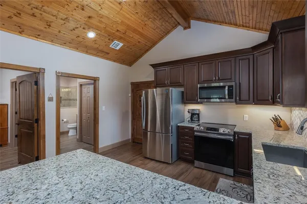 a kitchen with stainless steel appliances granite countertop a refrigerator stove and oven