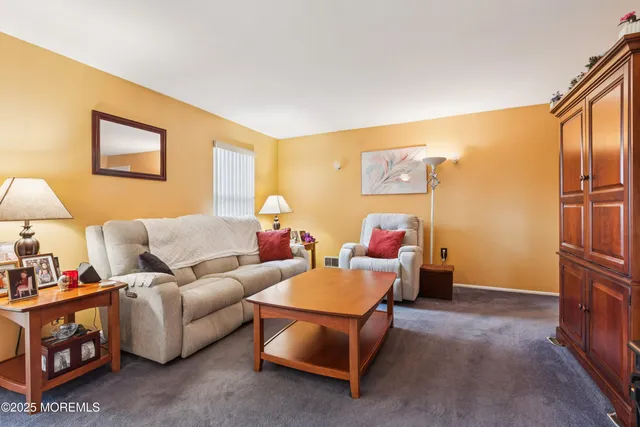 a living room with furniture and a baby crib