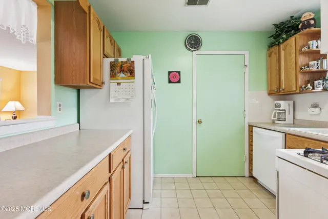 a kitchen with stainless steel appliances granite countertop a sink and a refrigerator