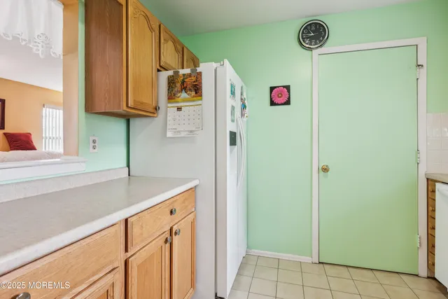 a kitchen with cabinets and wooden floor