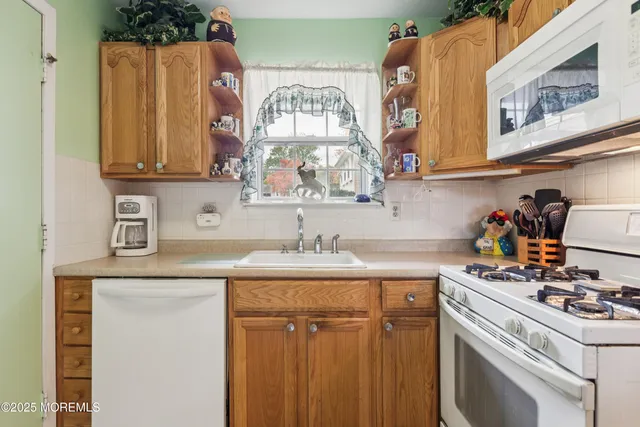 a kitchen with stainless steel appliances a sink a stove and a refrigerator
