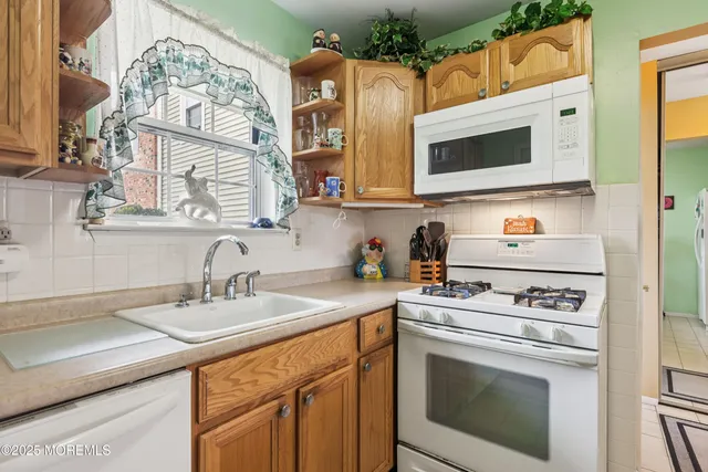 a kitchen with stainless steel appliances a stove a sink and a microwave