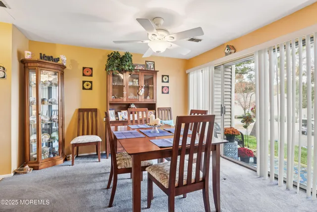 a dining room with furniture a chandelier and a rug