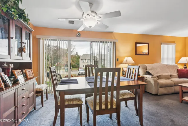 a dining room with furniture a rug and a large window