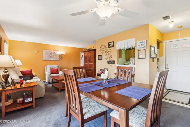 a view of a dining room with furniture and chandelier