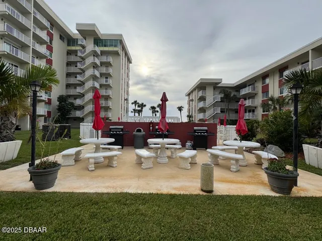 a view of two chairs and tables in the patio