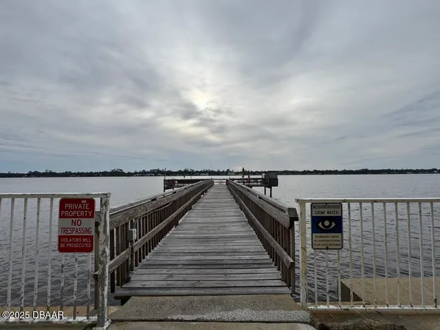 a view of a balcony with wooden floor and ocean view