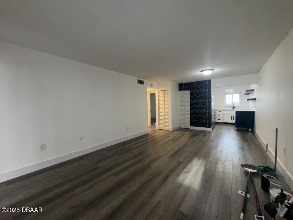 2711 North Halifax Avenue, Unit 385 Daytona Beach, FL 32118 - Photo 3 of 18 a view of empty room with wooden floor