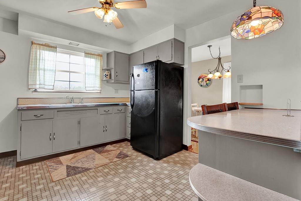 1689 4th Street Monongahela, PA 15063 - Photo 18 of 31 a kitchen with a sink a refrigerator and chandelier