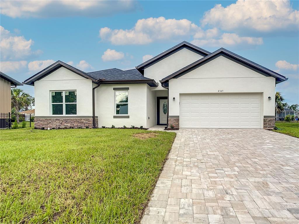 a front view of house with yard and green space