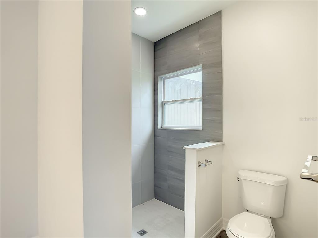 5123 Weatherton Street North Port, FL 34288 - Photo 11 of 16 a white toilet sitting next to a bathroom sink
