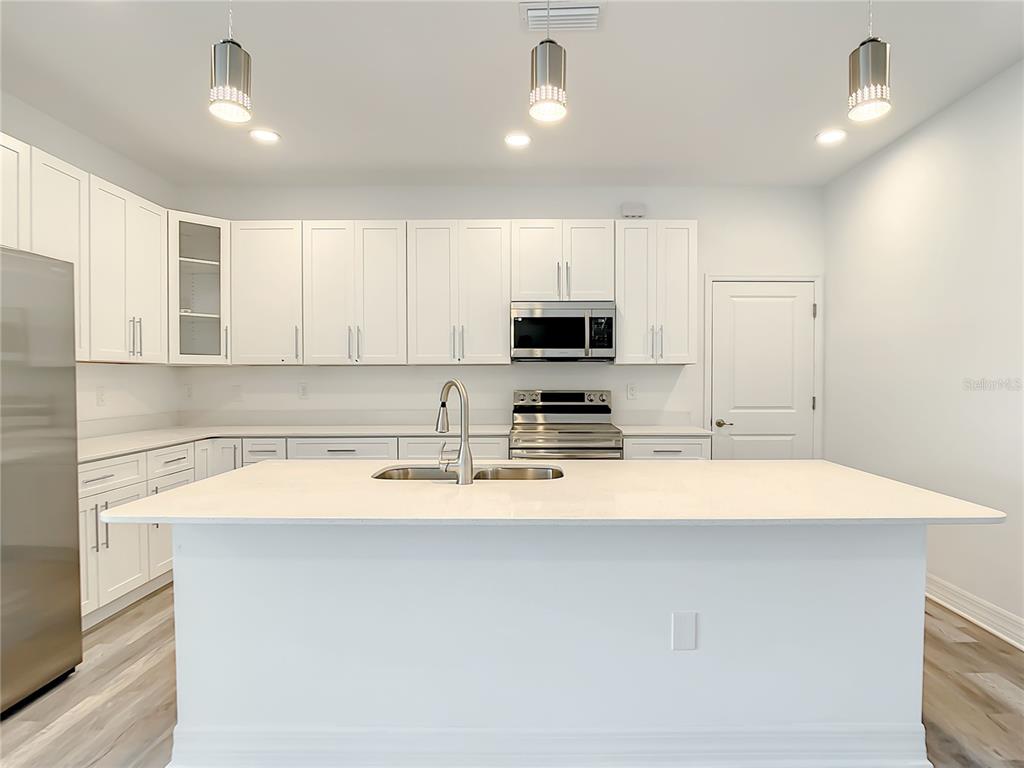 5123 Weatherton Street North Port, FL 34288 - Photo 3 of 16 a kitchen with appliances a sink and cabinets