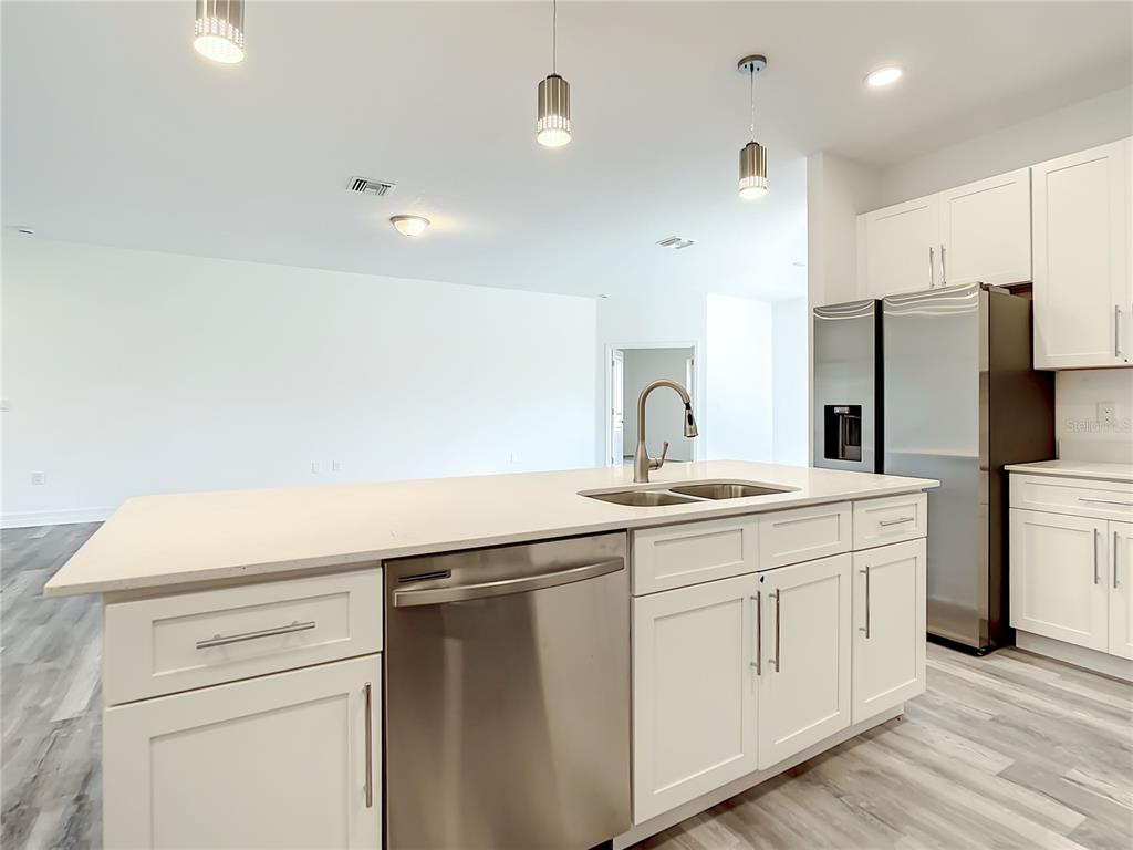 5123 Weatherton Street North Port, FL 34288 - Photo 4 of 16 a kitchen with a sink and refrigerator