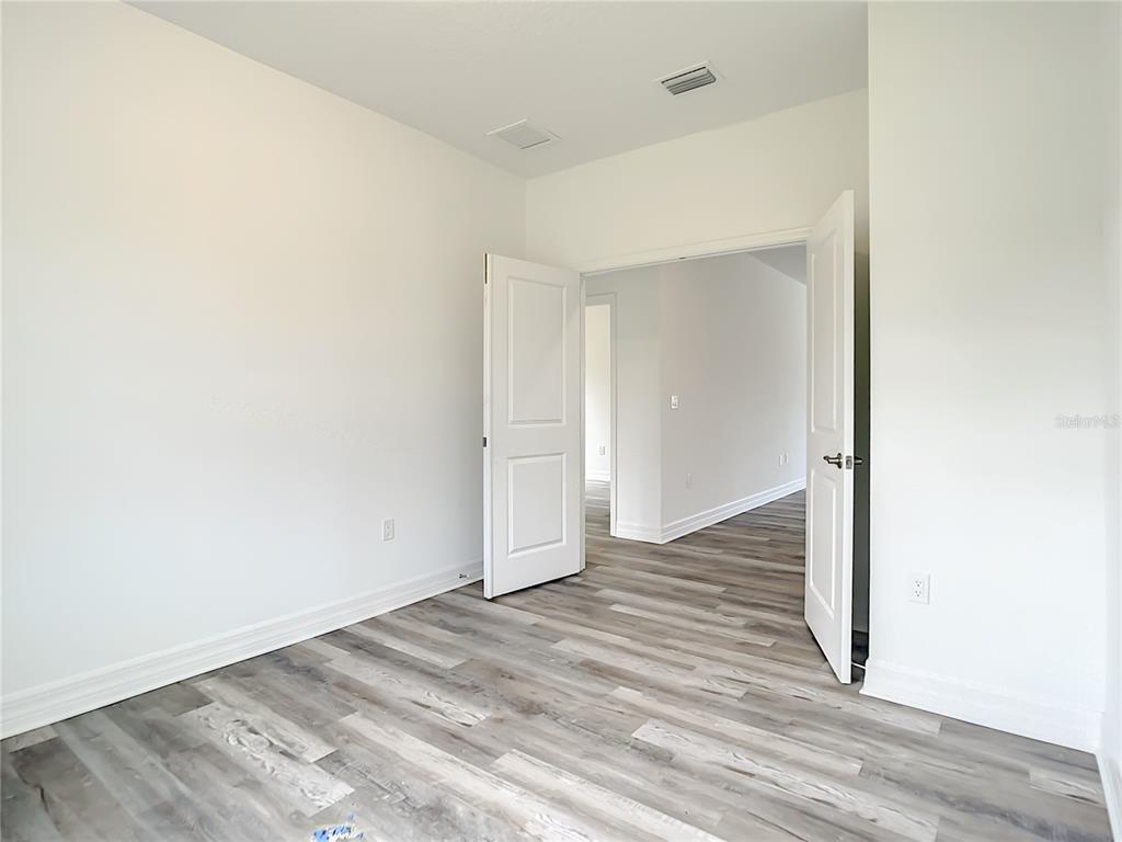 5123 Weatherton Street North Port, FL 34288 - Photo 9 of 16 a view of a room with wooden floor