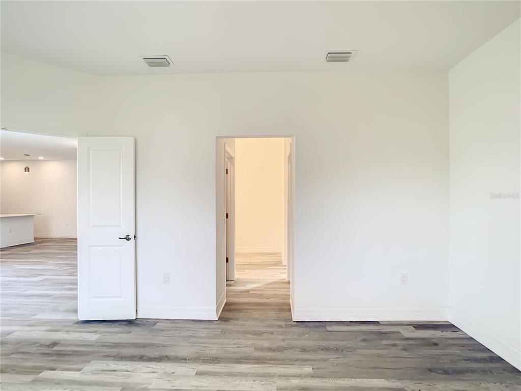 5123 Weatherton Street North Port, FL 34288 - Photo 10 of 16 an empty room with wooden floor and windows