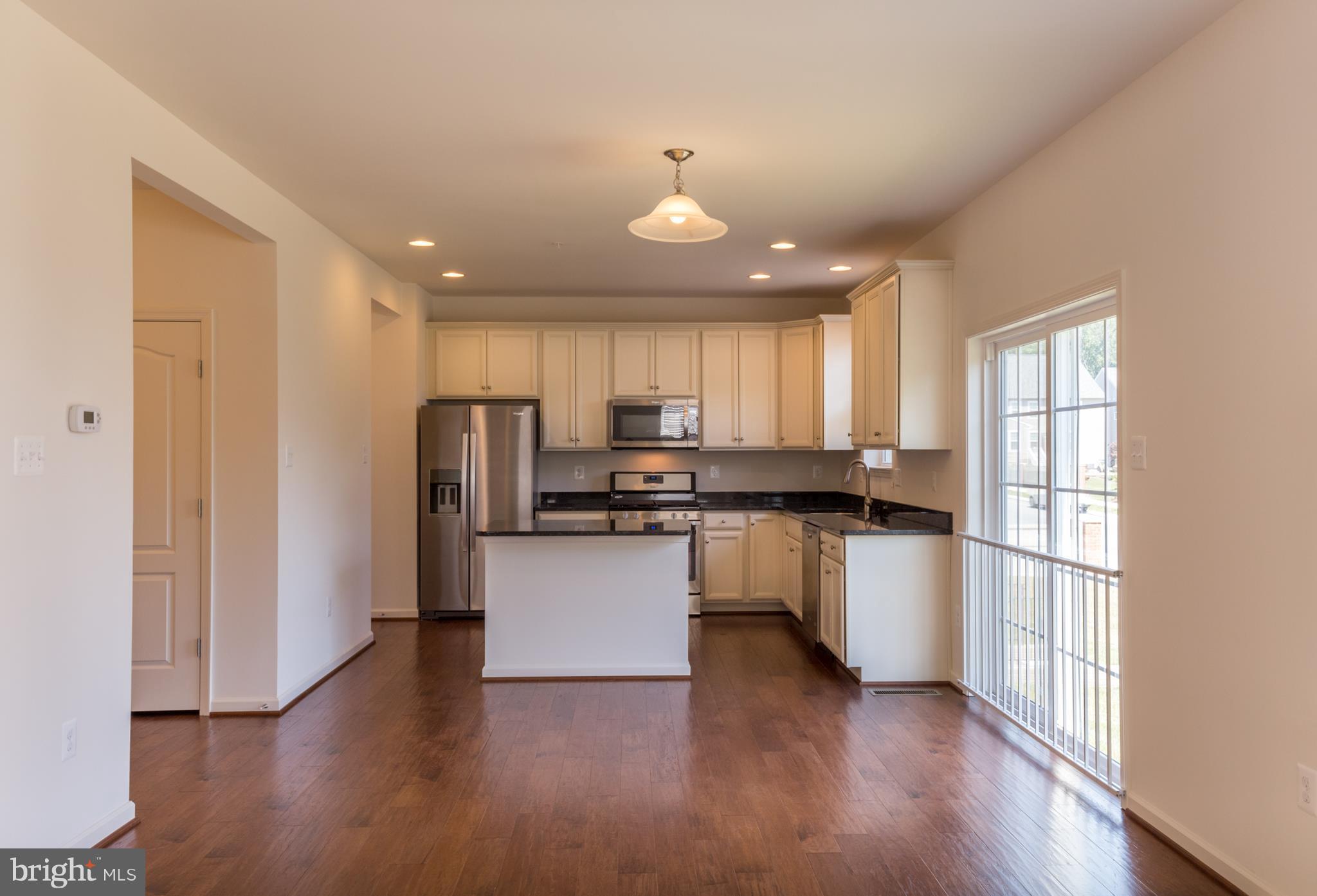 902 Ramble Run Road Middle River, MD 21220 - Photo 14 of 30 a kitchen with stainless steel appliances granite countertop a refrigerator sink and white cabinets