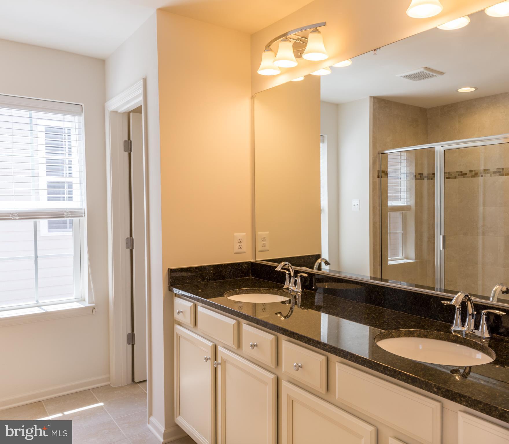 902 Ramble Run Road Middle River, MD 21220 - Photo 20 of 30 a bathroom with a granite countertop sink and a mirror