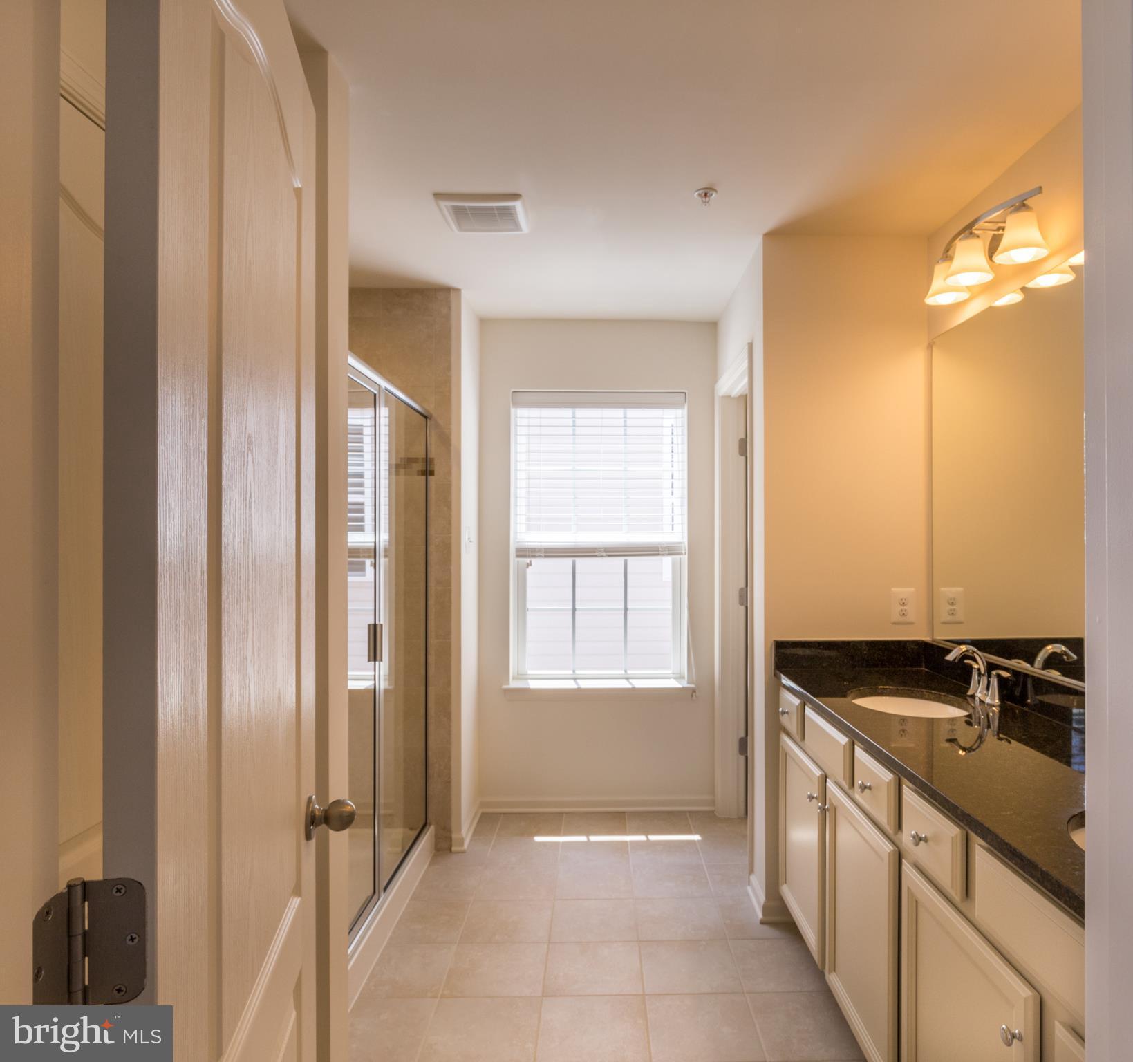 902 Ramble Run Road Middle River, MD 21220 - Photo 21 of 30 a bathroom with a granite countertop sink and a mirror