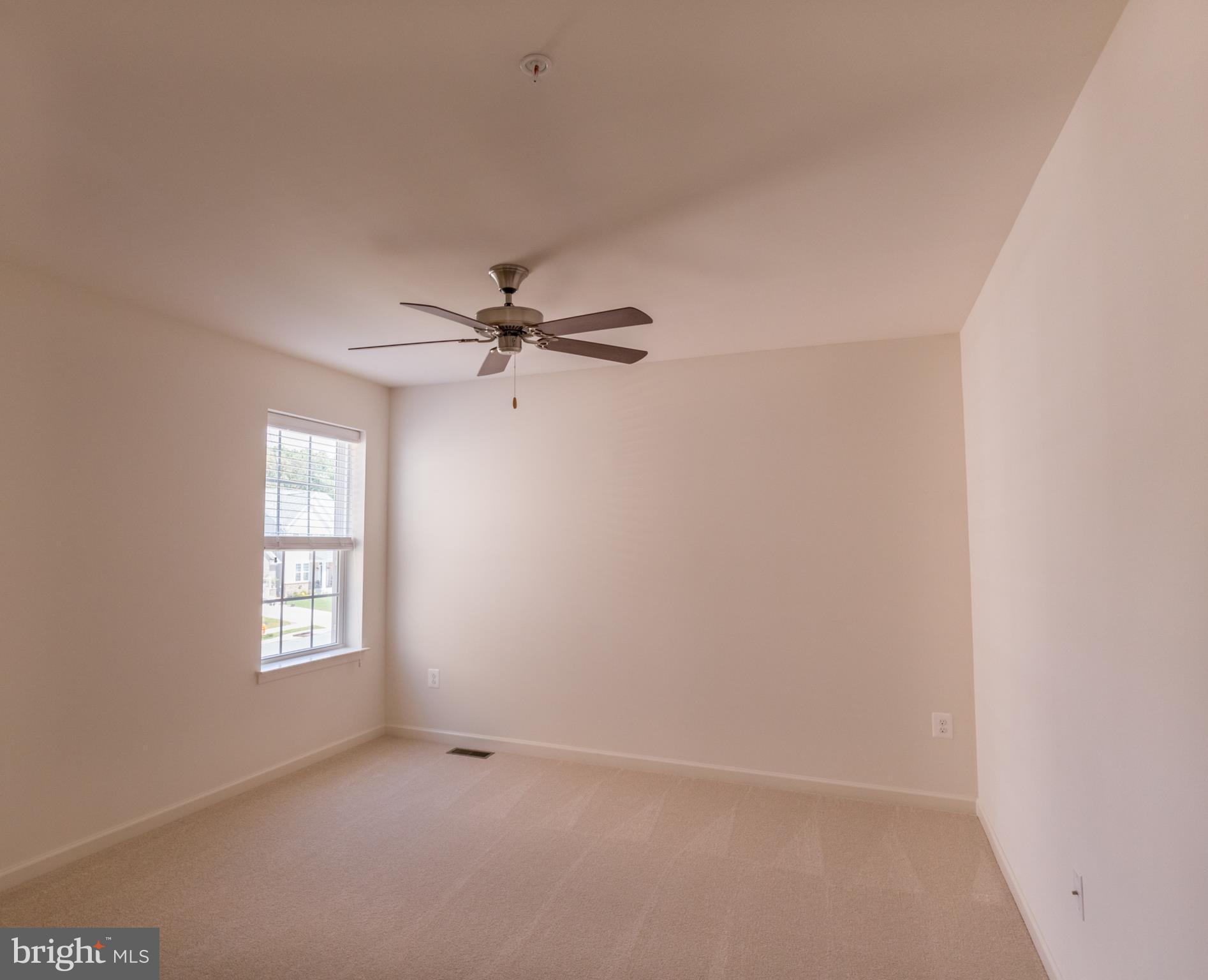 902 Ramble Run Road Middle River, MD 21220 - Photo 23 of 30 an empty room with windows and fan