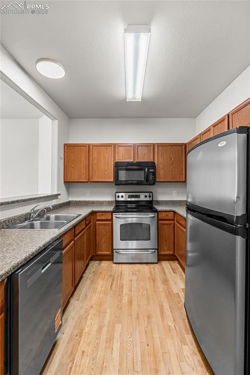 7795 Sandy Springs Point Fountain, CO 80817 - Photo 11 of 36 a kitchen with stainless steel appliances granite countertop a stove a sink and a refrigerator