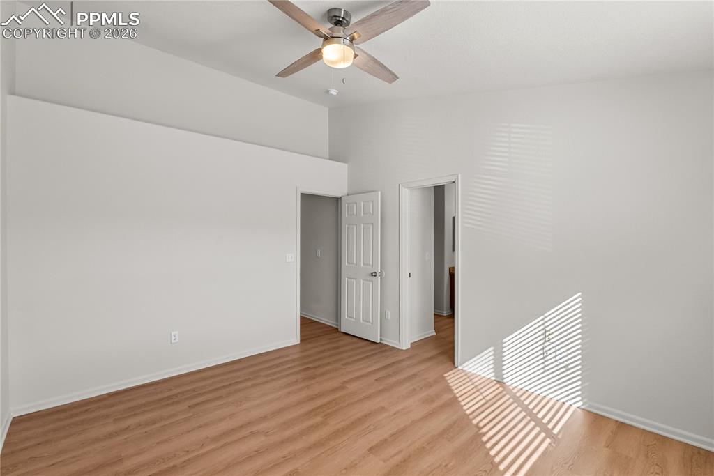 7795 Sandy Springs Point Fountain, CO 80817 - Photo 12 of 36 an empty room with wooden floor fan and windows