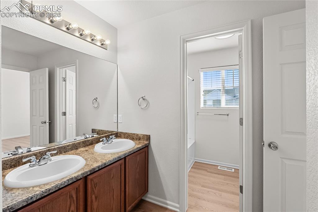 7795 Sandy Springs Point Fountain, CO 80817 - Photo 14 of 36 a bathroom with a granite countertop sink and a mirror