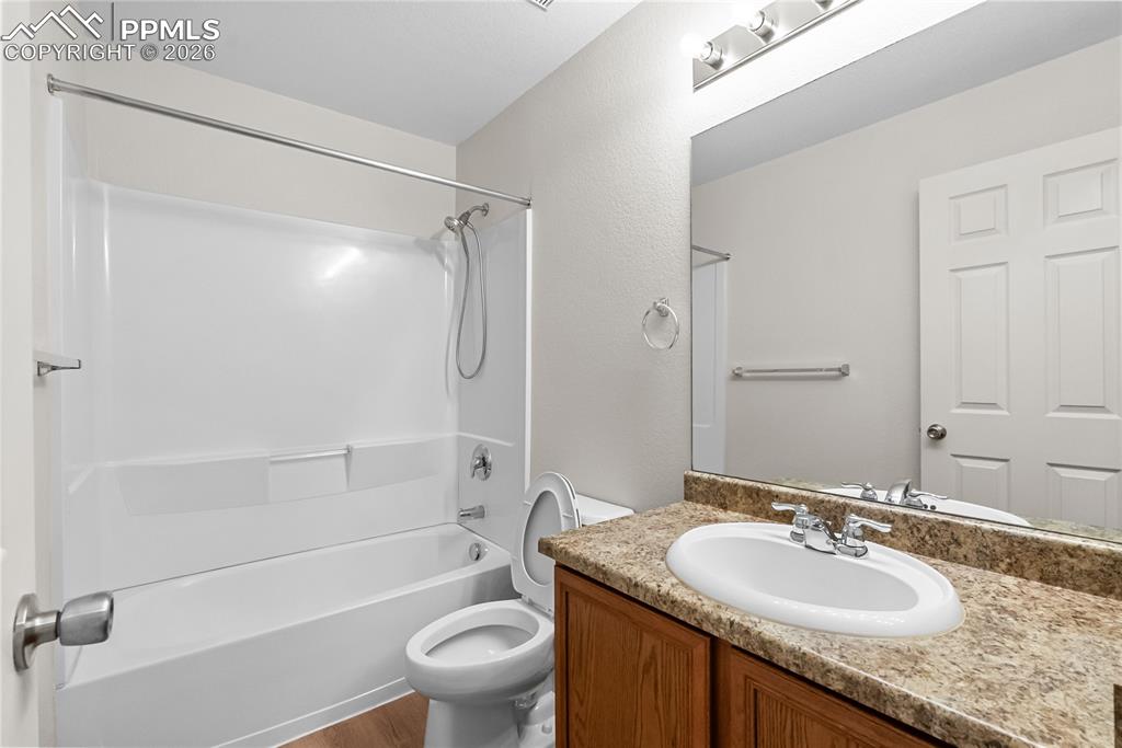 7795 Sandy Springs Point Fountain, CO 80817 - Photo 19 of 36 a bathroom with a granite countertop sink toilet and shower
