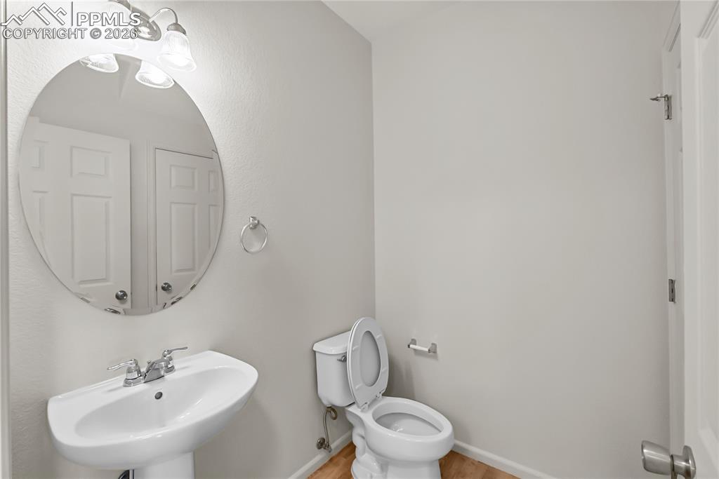 7795 Sandy Springs Point Fountain, CO 80817 - Photo 22 of 36 a bathroom with a toilet sink and mirror