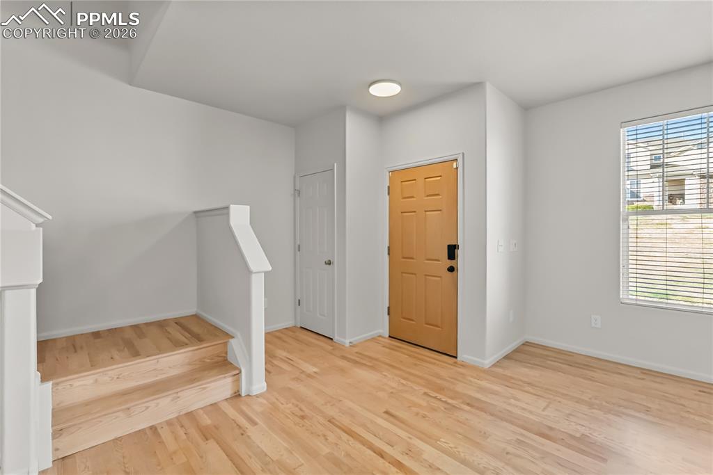 7795 Sandy Springs Point Fountain, CO 80817 - Photo 3 of 36 an empty room with wooden floor and windows