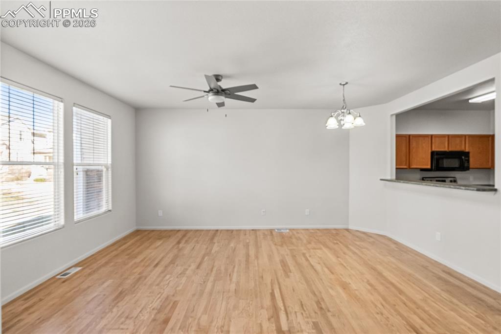 7795 Sandy Springs Point Fountain, CO 80817 - Photo 5 of 36 wooden floor in an empty room with a window