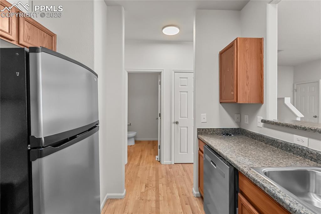 7795 Sandy Springs Point Fountain, CO 80817 - Photo 8 of 36 a kitchen with a refrigerator and a sink