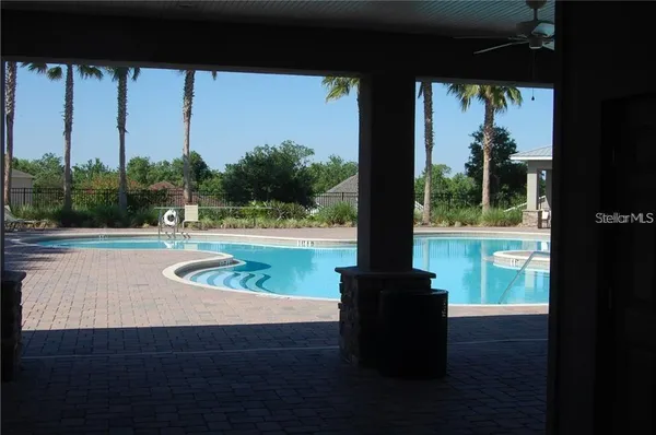 a view of a porch with a floor to ceiling window and a yard