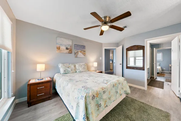 a bedroom with a large bed and a chandelier