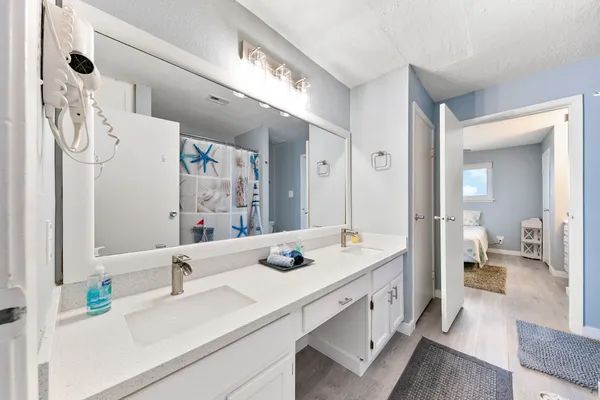 a en suite bathroom with double vanity a mirror and double